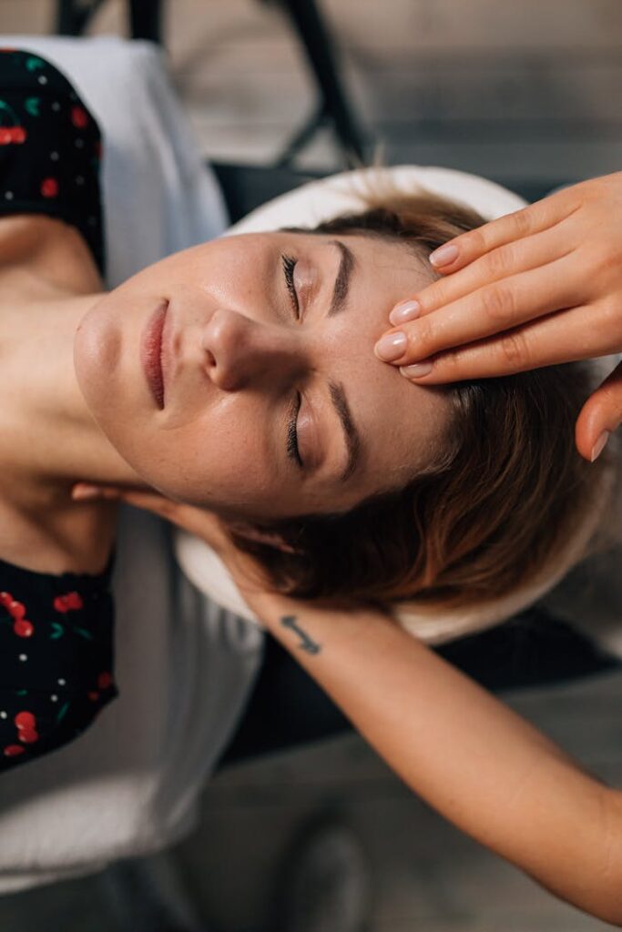 Woman receiving a soothing facial massage for ultimate relaxation and self care in a spa setting.